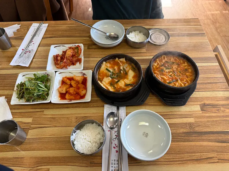 테이블 위에 놓인 어탕수제비와 기본 반찬들의 모습. 푸짐한 한 상 차림이 인상적이다.