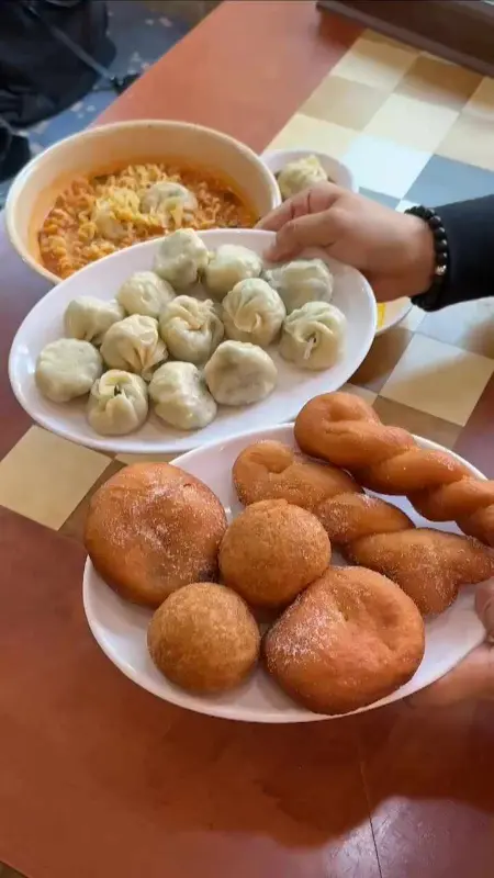 만두, 꽈배기, 라면이 테이블에 놓여져 있는 모습