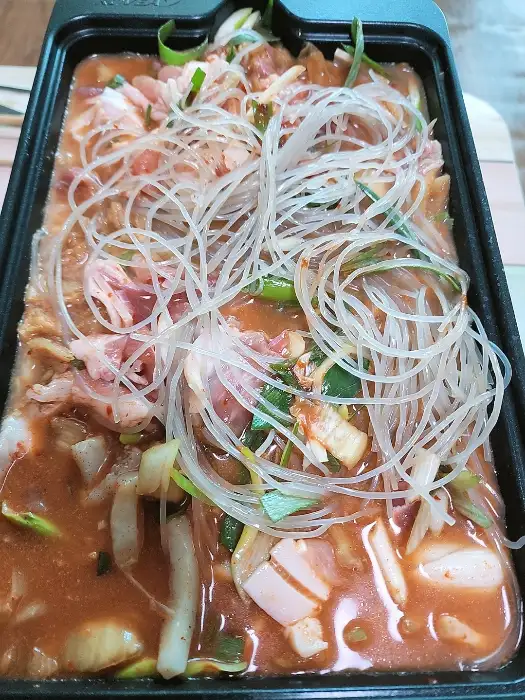 면과 고기가 푸짐하게 담긴 돼지찌개