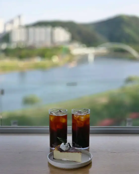 창밖으로 보이는 태화강 풍경과 커피, 디저트