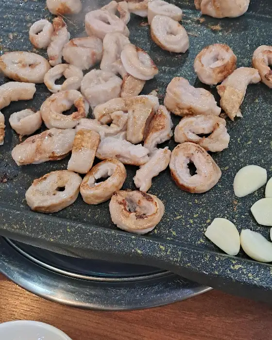 잘 구워진 막창과 콩나물, 마늘