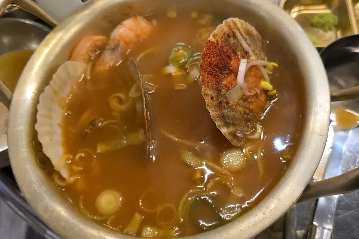 키조개에 치즈와 양념이 올라가 구워지는 모습