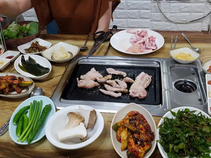 다양한 종류의 밑반찬들이 테이블을 가득 채우고 있습니다.