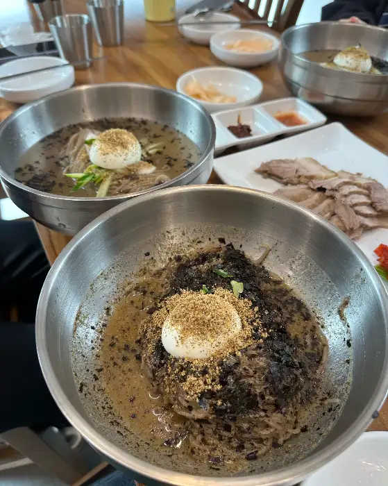 수육 한 접시와 막국수 모습, 수육이 먹음직스럽게 담겨 있다.