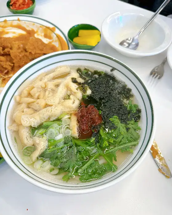 쫄면이 담긴 그릇. 붉은 양념에 신선한 채소와 면이 어우러져 먹음직스럽다.