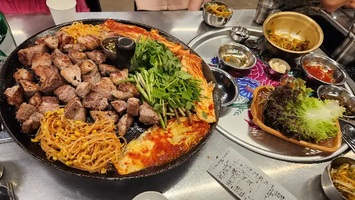 삼겹살, 목살, 갓김치, 파절이, 콩나물무침 등이 함께 나온 푸짐한 한상차림