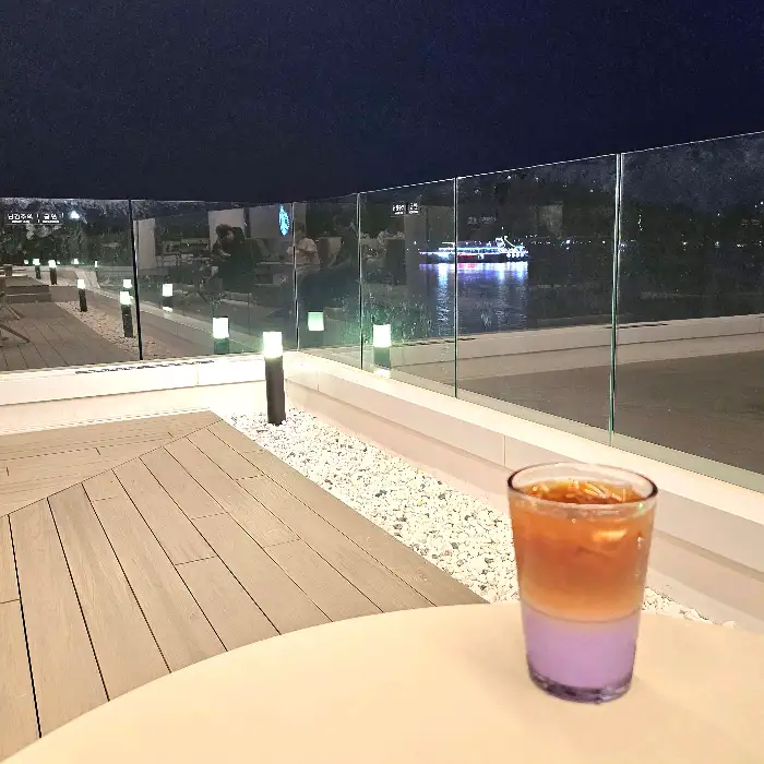 밤의 바다 풍경과 함께 놓인 음료