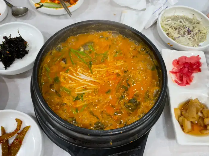 메기탕이 담긴 뚝배기와 밑반찬
