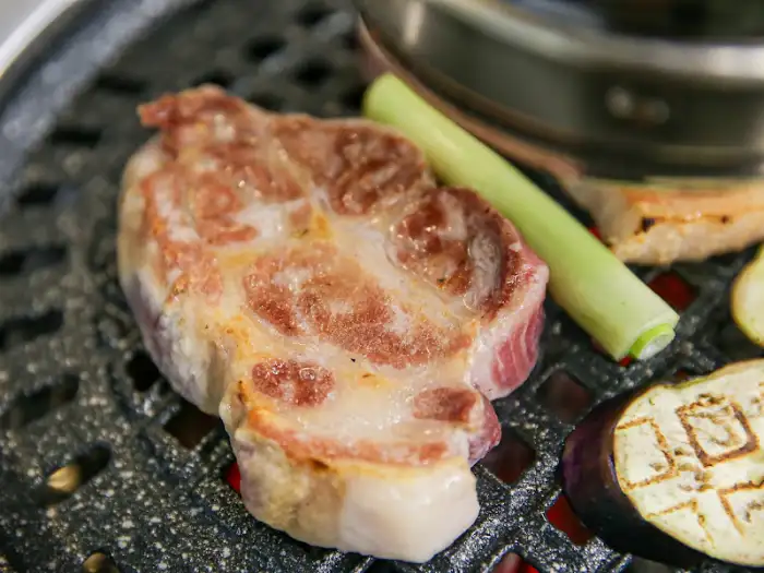 불판 위에서 맛있게 익어가고 있는 돼지 목살 부위