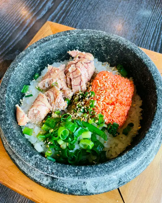 뜨거운 돌솥에 담긴 밥과 얹어진 젓갈