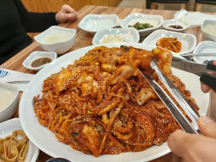 푸짐하게 담긴 해물아귀찜 사진. 다양한 해산물과 콩나물이 붉은 양념에 버무려져 있다.