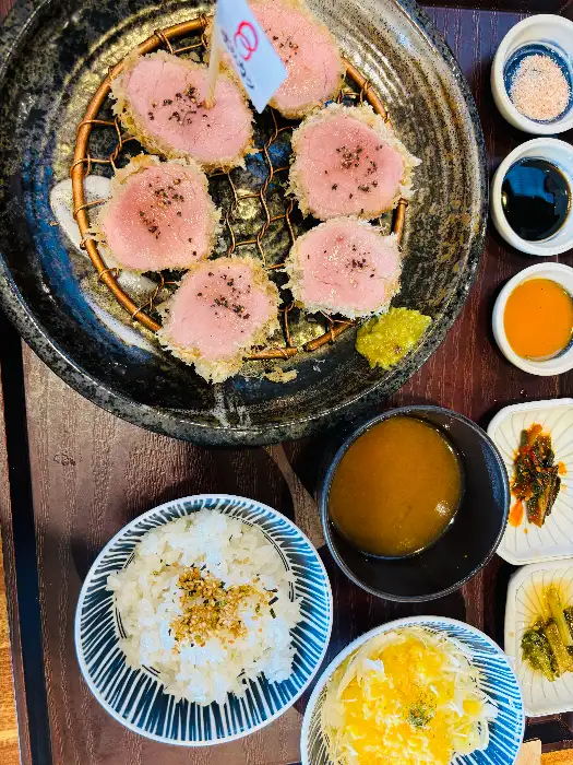 돈까스와 밥, 다양한 소스와 반찬이 함께 나온 모습