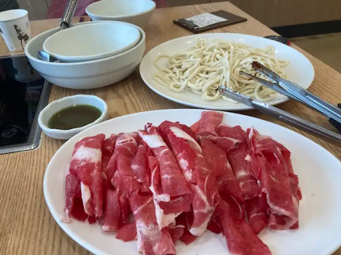 샤브샤브용 고기와 칼국수 사리가 담긴 솥