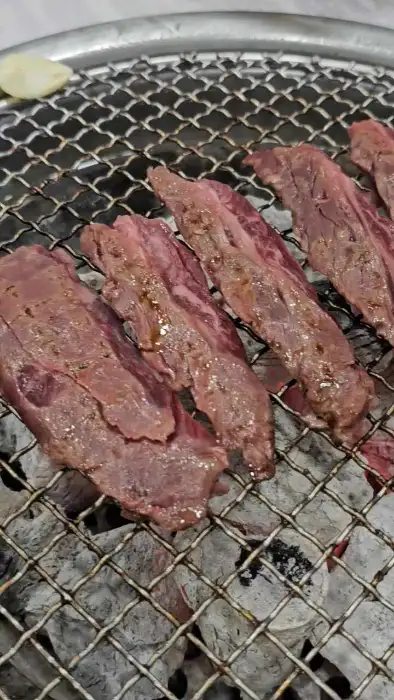 다양한 부위의 고기가 불판 위에서 익어가고 있는 모습