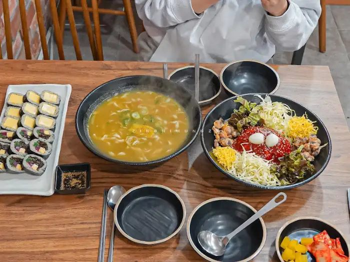 식당 내부의 테이블과 음식들, 사람들이 함께 앉아 식사하는 모습